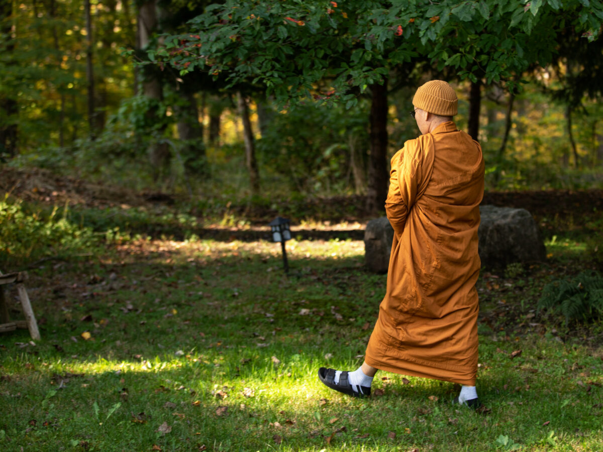 Achan Da walking on the grounds of the Wenham Center